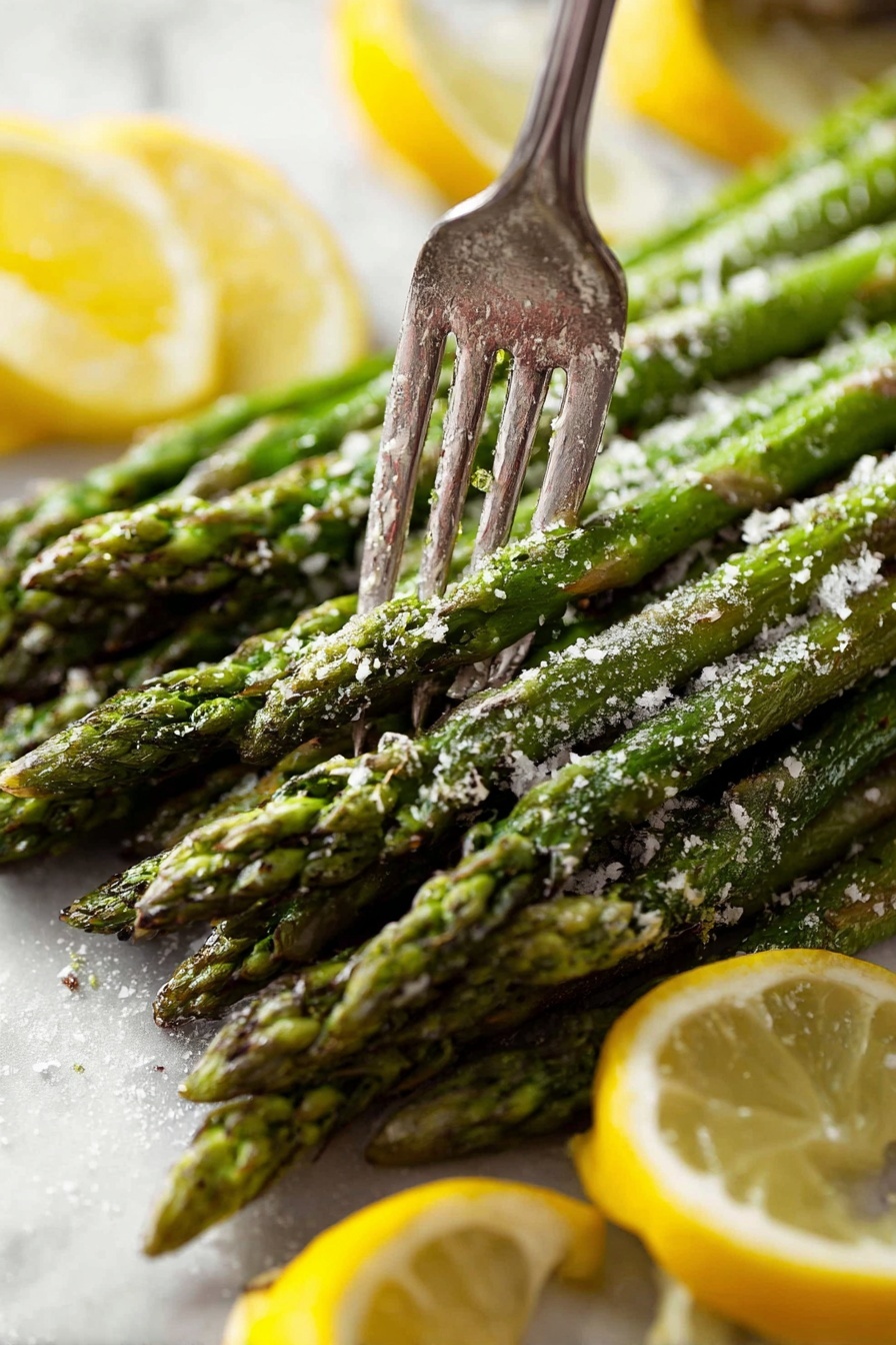 A bunch of green asparagus spears stacked closely together with a rough texture from seasoning on top, including white grated cheese or salt. A silver fork is pressing down on the spears near the tips, piercing through multiple spears. Around the asparagus, there are thin lemon slices with bright yellow skin and juicy inner flesh. The background is a white marbled texture. photo taken with an iphone --ar 2:3 --v 7