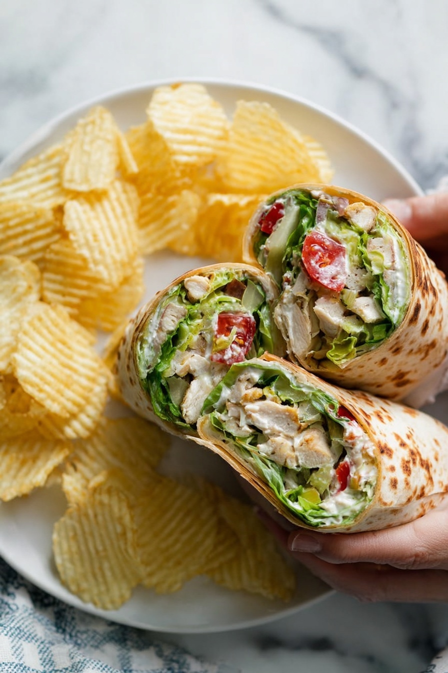 The image shows a close-up of five wrap halves stacked together, each with a light brown toasted flatbread outer layer that has dark grilled spots. Inside, there are three main layers: bright green leafy lettuce, chunks of creamy pale avocado, and white pieces of cooked chicken, all mixed with halved red cherry tomatoes. A creamy white dressing is drizzled throughout the filling, speckled with black pepper. The wraps sit on white marbled paper, with some filling pieces and pepper flakes scattered around. photo taken with an iphone --ar 2:3 --v 7