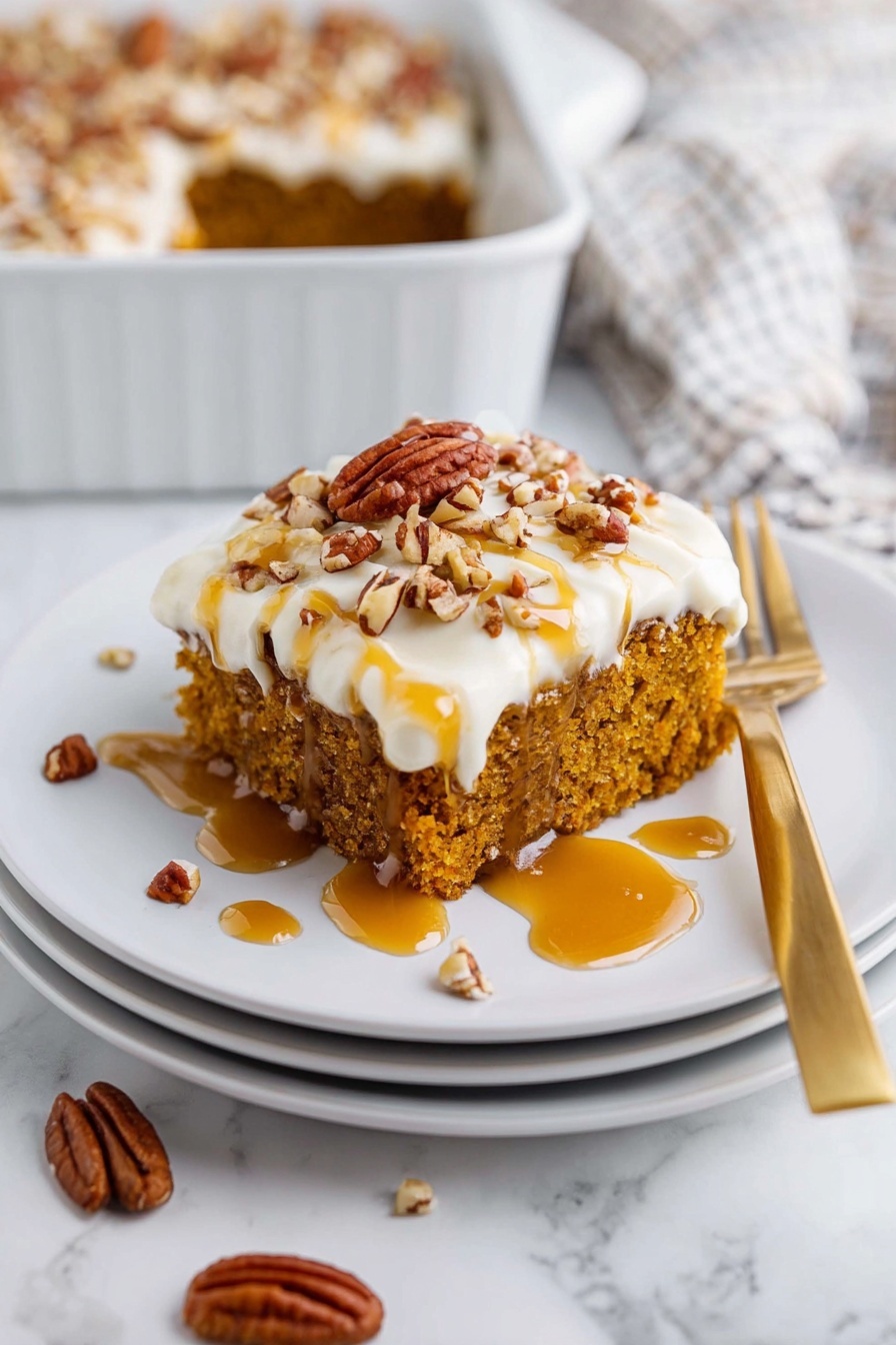 A square piece of orange-brown cake with a rough, soft texture sits on a stack of three white plates. The cake has a thick layer of smooth white frosting on top, sprinkled with chopped pecans in varying sizes. Golden caramel sauce is drizzled over the frosting and around the plate, with a few whole pecans scattered on the plate. A gold fork is placed beside the cake on the top plate, and the background shows a white marbled surface with a white baking dish partially visible, also containing the remaining cake. Photo taken with an iphone --ar 2:3 --v 7