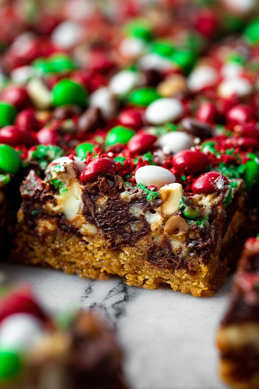 This image shows a rich dessert bar with three main layers: at the bottom is a thick, golden-brown crust that looks crunchy and firm. Above the crust is a dense, dark chocolate layer mixed with melted white bits, creating a marbled effect. The top layer is a festive mix of red, green, and white candy-coated chocolates and nuts, scattered thickly and unevenly over the chocolate, adding bright pops of color and texture. The background is a white marbled texture, and the photo focuses closely on the front edge of the bar, showing the melty, chunky surface in sharp detail while the rest of the bars blur into the background. photo taken with an iphone --ar 2:3 --v 7