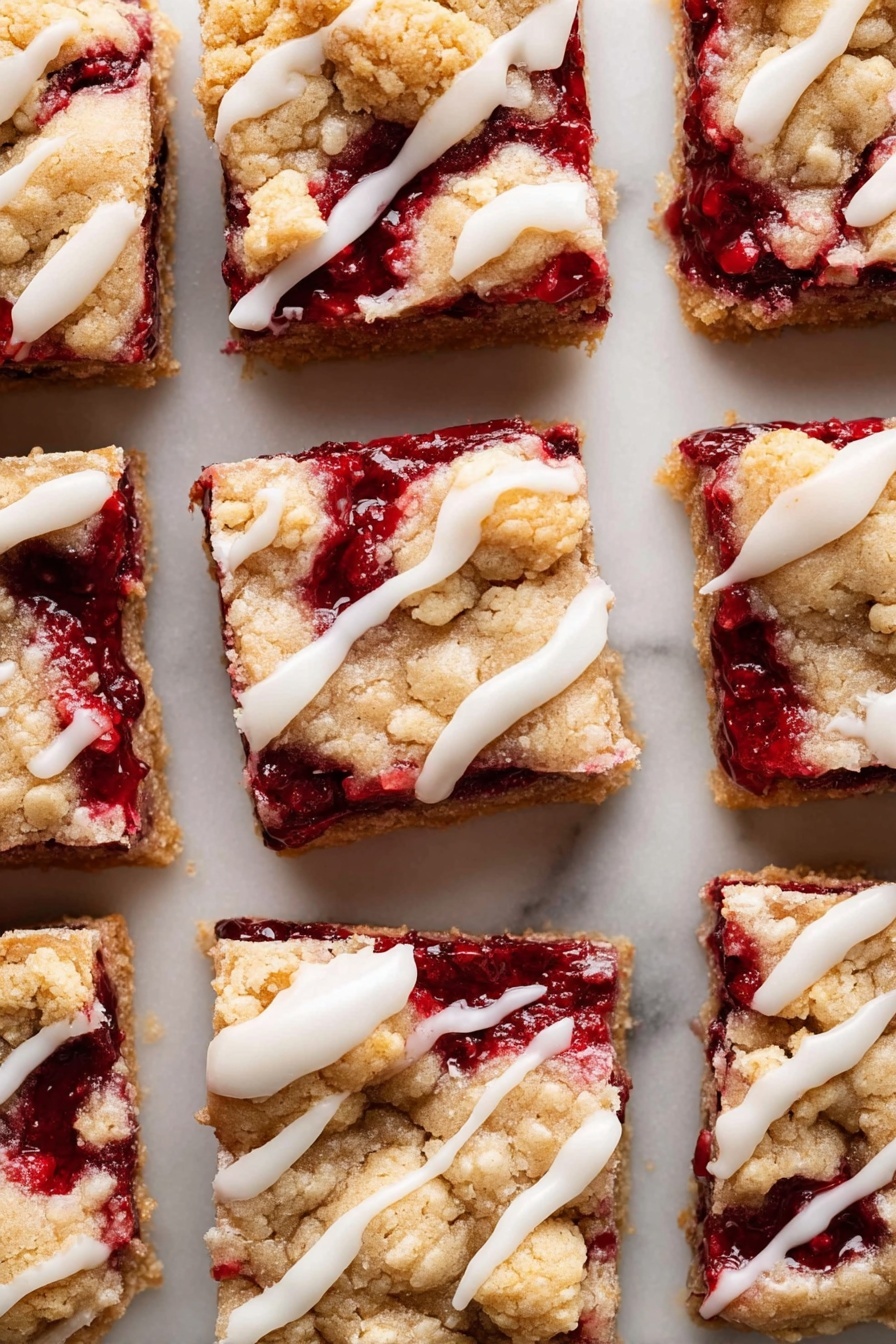The image shows nine square pieces of berry dessert bars arranged closely on a white marbled surface. Each bar has two main layers: a bottom layer of deep red berry filling that looks thick and slightly shiny, and a top layer of golden brown crumbly dough with a rough texture. The top layer is irregular and cracked in places, revealing the berry filling underneath. White icing is drizzled unevenly across the top of each piece, adding a smooth and glossy contrast to the crumbly dough. The bars are evenly spaced but fill most of the frame, showing their texture and color clearly. photo taken with an iphone --ar 2:3 --v 7