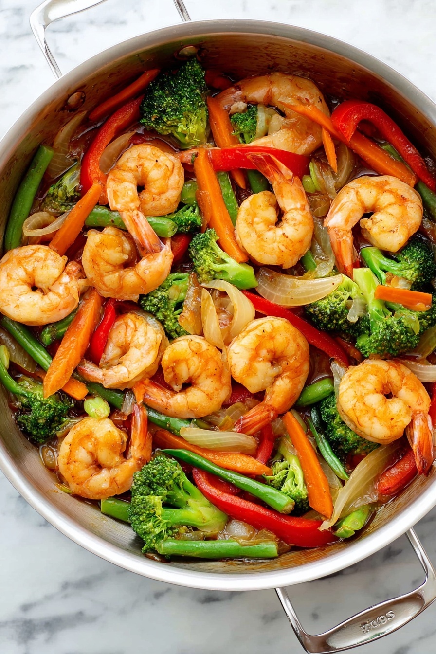 Inside a shiny silver cooking pot, there is a colorful mix of cooked shrimps and vegetables. The shrimps are orange with some light shades, curled and spread all over. Bright green broccoli florets, long orange carrot strips, red bell pepper slices, and green beans add color and texture around the shrimps. Some pieces of cooked onion, pale and translucent, are mixed in. Everything looks glossy with a light brown sauce coating it. The pot is placed on a white marbled surface. photo taken with an iphone --ar 2:3 --v 7