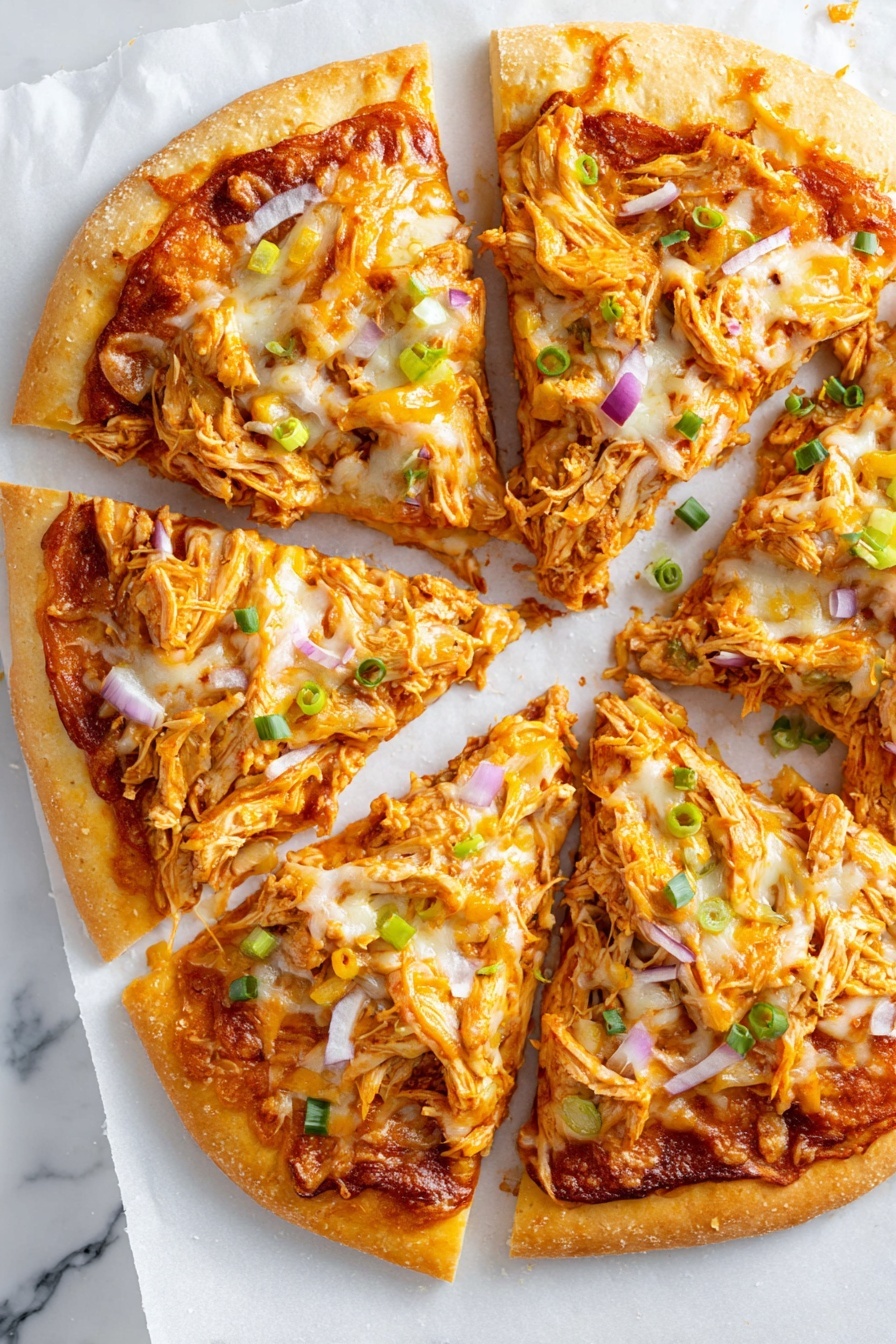 The image shows a pizza sliced into six pieces on a white marbled surface with a layer of white parchment paper underneath. The pizza has a golden crust around the edges. The first layer is a reddish-brown sauce spread evenly on the dough, followed by an orange and white layer of melted cheese covering the top. There are shredded pieces of orange chicken scattered across each slice with some yellow bell pepper slices and small bits of green onion sprinkled over the cheese. Thin slices of purple onion are also mixed in with the toppings. The texture looks soft and cheesy with some slightly browned edges. Photo taken with an iphone --ar 2:3 --v 7