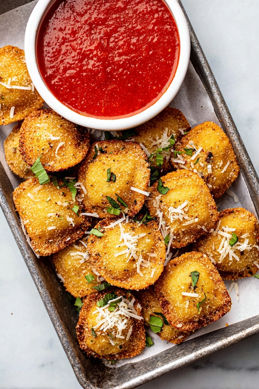 A metal tray with white paper holds many small, round, golden-brown fried balls with a crispy texture, each topped with small shreds of white cheese and chopped green herbs. To the top right of the tray, there is a white bowl filled with thick, bright red tomato sauce that looks smooth but slightly chunky. The tray rests on a white marbled surface. photo taken with an iphone --ar 2:3 --v 7