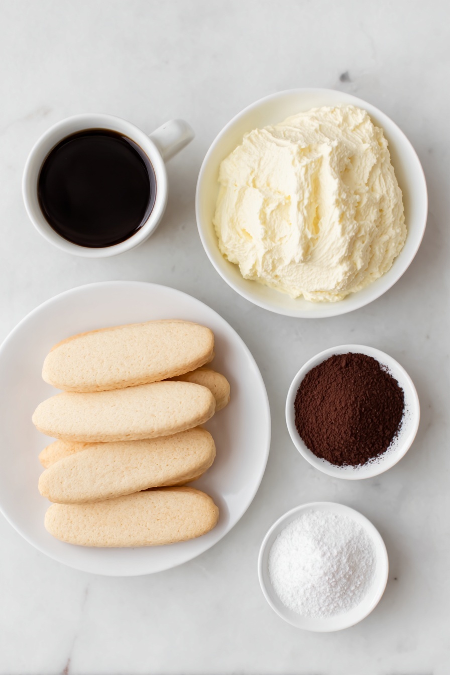 Flat lay of a small mound of fresh mascarpone cheese on a simple white ceramic plate, a neat stack of whole unbroken savoiardi ladyfinger biscuits beside it, a small white bowl filled with dark brewed espresso coffee, a small white bowl containing finely sifted powdered sugar, and another small white bowl with rich cacao powder for dusting, all arranged with perfect symmetry and balanced proportions, placed on a clean white marble surface, soft natural light, photo taken with an iPhone, professional food photography style, fresh ingredients, white ceramic bowls, no bottles, no duplicates, no utensils, no packaging --ar 2:3 --v 7 --p m7354615311229779997