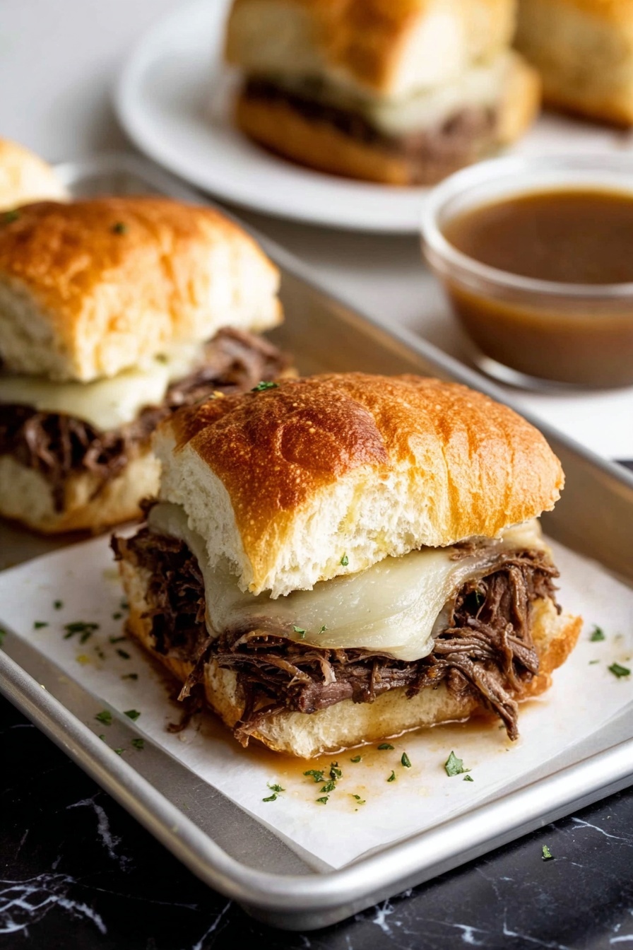 A close-up view of a sandwich with three layers: a golden, crusty white roll sliced open with a soft inside on top; in the middle, a thick layer of dark, shredded meat filling with a slightly rough texture; on the bottom of the meat, a melted layer of light-colored cheese that looks smooth and soft, melting slightly over the meat; the sandwich is on a piece of white paper on a metal tray, with small green herb pieces sprinkled around. In the blurry background, there is another sandwich on a white plate and a glass bowl with brown sauce, all on a white marbled surface. photo taken with an iphone --ar 2:3 --v 7